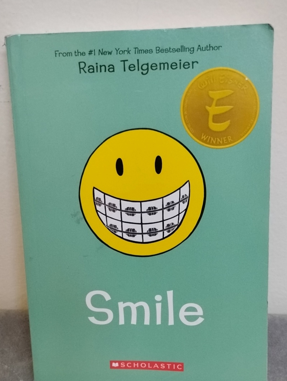 D- Smile by Raina Telgemeier - Mint Green Cover with Yellow Smiley